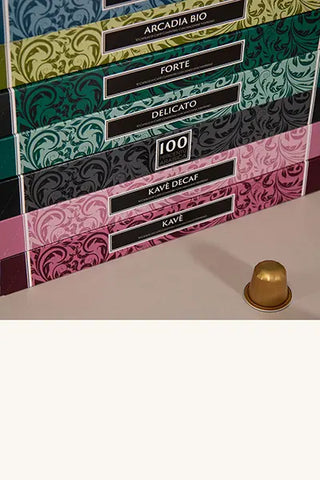 Nespresso-compatible aluminum coffee capsule tube-shaped boxes with a capsule in the foreground.